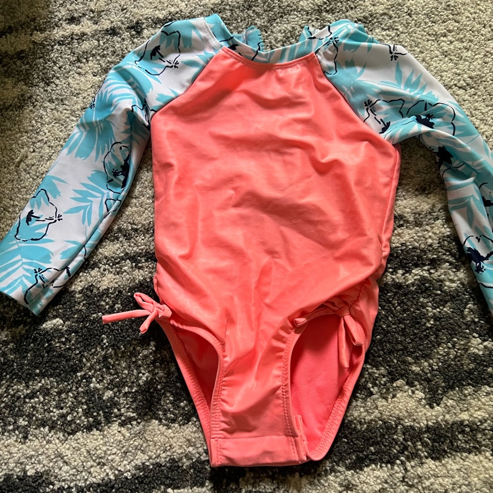 Cat at jack one piece rash guard with snap at bottom.